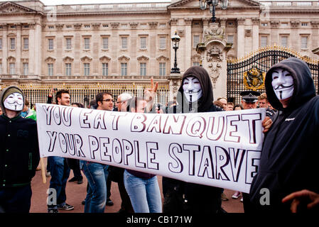 LONDON, UK - 18th May 2012: Occupy London and Anonymous protesters in front of Buckingham Palace denouncing the presence of the King of Bahrain and other country leaders in visit at Buckingham Palace for the Queen's Jubilee. Stock Photo