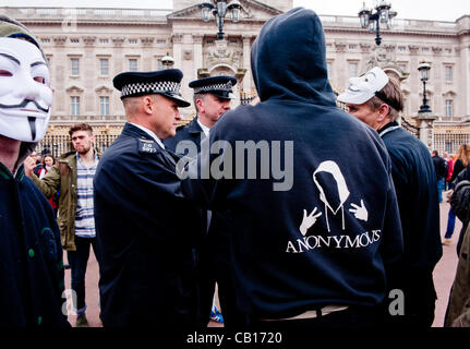 LONDON, UK - 18th May 2012: Occupy London and Anonymous protesters in front of Buckingham Palace denouncing the presence of the King of Bahrain and other country leaders in visit at Buckingham Palace for the Queen's Jubilee. Stock Photo
