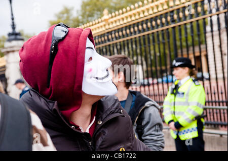 LONDON, UK - 18th May 2012: Occupy London and Anonymous protesters in front of Buckingham Palace denouncing the presence of the King of Bahrain and other country leaders in visit at Buckingham Palace for the Queen's Jubilee. Stock Photo