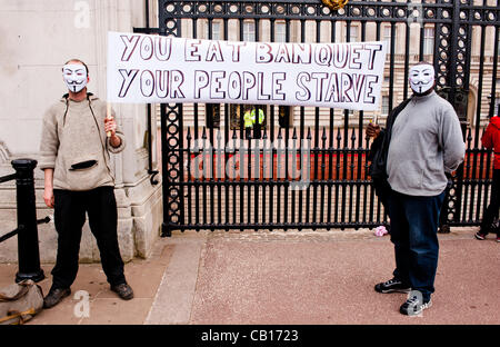 LONDON, UK - 18th May 2012: Occupy London and Anonymous protesters in front of Buckingham Palace denouncing the presence of the King of Bahrain and other country leaders in visit at Buckingham Palace for the Queen's Jubilee. Stock Photo