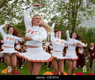 18 May 2012 London UK, The Cheerleaders of University of Southern California Trojans Marching Band show off their skills but fail to bring the sun on Potters Field in London, UK. The performance which was part of their pre-Olympic tour of London. Stock Photo