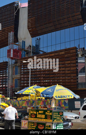 New York - May 18, 2012 - A hot dog vendor outside the Barclays Center at Atlantic Yards, new home of the newly renamed Brooklyn Nets basketball team, during construction. The 18,000 seat arena in Brooklyn New York opens October 3, 2012 with a sold out inaugural concert by Jay Z. Stock Photo