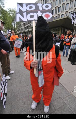 An anti Nato protester wearing a Guantanamo Bay style prisoner jump suit outside the American Embassy as part of the Stop the War Coalition and anti Nato protest. Saturday 19th May 2012 Stock Photo