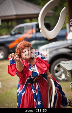 A competitor throws a toilet seat during the Toilet Seat Horse Shoe contest at the Summer Redneck Games on May 26, 2012 in East Dublin, Georgia. Stock Photo