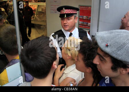 Monday 28th May 2012 Pay Up group's first direct action against Sainsbury's . City of London Police officers tried to prevent the activists from entering the Fetter Lane branch of the store. Credit Line : Credit:  HOT SHOTS / Alamy Live News Stock Photo