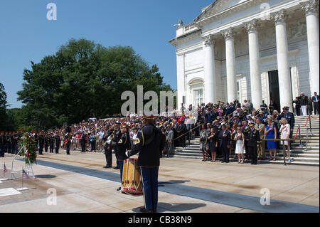 US President Barack Obama stands for a moment of silence at the Tomb of the Unknowns at Arlington National Cemetery May 28, 2012 in Arlington, VA Stock Photo