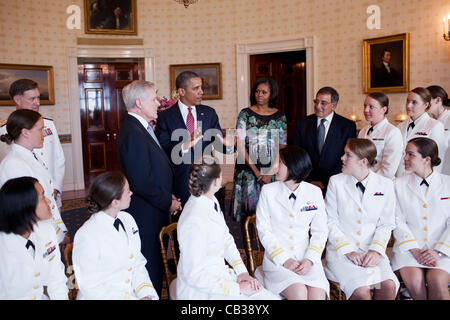 US President Barack Obama and First Lady Michelle Obama greet the Navy’s first contingent of women submariners to be assigned to the Navy’s operational submarine force in the Blue Room of the White House May 28, 2012 in Washington, DC. The 24 women were accepted into the Navy’s nuclear submarine pro Stock Photo