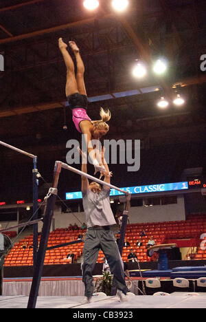 Nastia Liukin practices her uneven bars routine during training period practice at the UIC Pavillion in Chicago the day before their competition taking place May 26th.  Some of the women will find a place on the U.S. Olympic team going to London this summer. Stock Photo