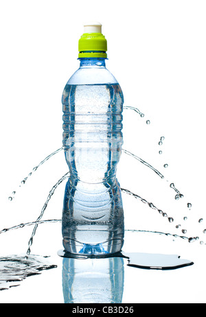 Blue bottle of water leaking. Small bubbles inside, reflection below and puddles besides. Isolated on white background. Stock Photo