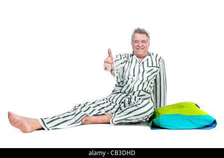 Senior man in pajamas isolated in white Stock Photo