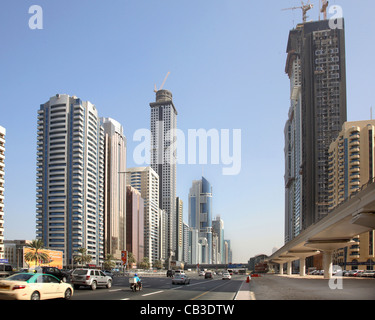 Tower blocks of Dubai's Financial District on Sheikh Zayaed Road. Shows the elevated Dubai Metro Line to Right Stock Photo