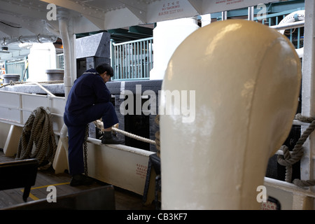 crewman with mooring rope on star ferry hong kong island hksar china Stock Photo