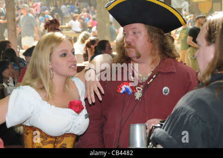 3 people dressed in Medieval costumes talk at the Renaissance Festival in Crownsville, Maryland Stock Photo