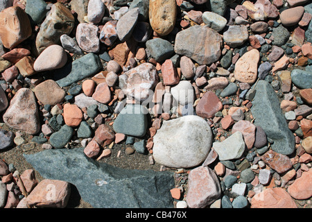 rounded smooth gray, white, and red rock and sand background Stock Photo