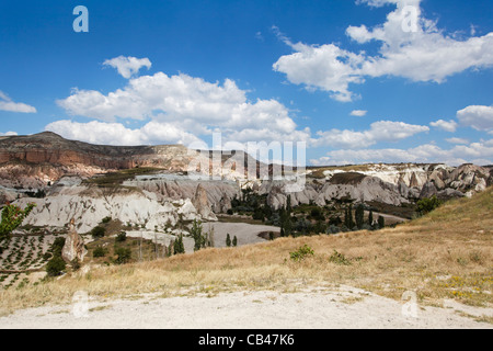 shadows of clouds and stray sunbeams volcanic ash mountains showing layers of activity, limestone and sandstone formation Stock Photo