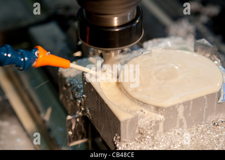 CNC Milling machine cutting with coolant Stock Photo