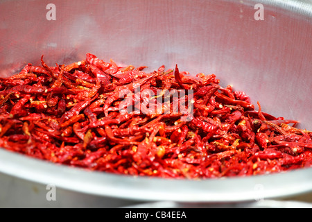 Chili peppers drying in the sun in Thailand. Stock Photo