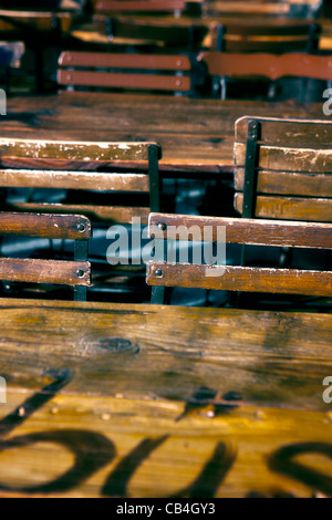 old wooden chairs and tables on a terrace of a pub Stock Photo
