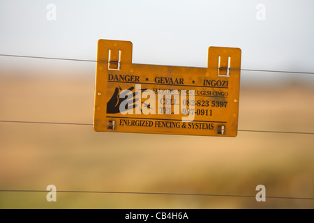 Security electric fence warning sign in South Africa Stock Photo