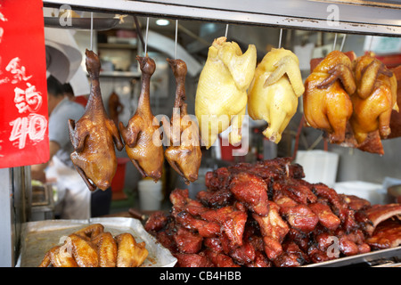 siu mei roasted meats hanging in a takeaway window kowloon hong kong china Stock Photo