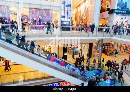 Bullring shopping centre interior, Birmingham, UK. People using an escalator at the Bullring shopping mall. Stock Photo