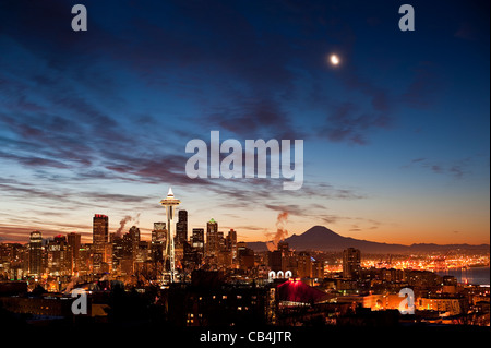 Retro image of Early morning sunrise looking over downtown Seattle with moon, Space Needle and Mount Rainier Stock Photo