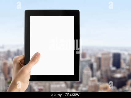 Man hands are holding touch screen device with blank screen. Blurred cityscape with skyscrapers on background. Stock Photo