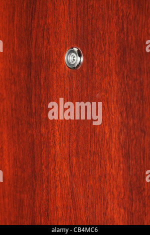 Peephole on wooden door - judas hole spyhole Stock Photo