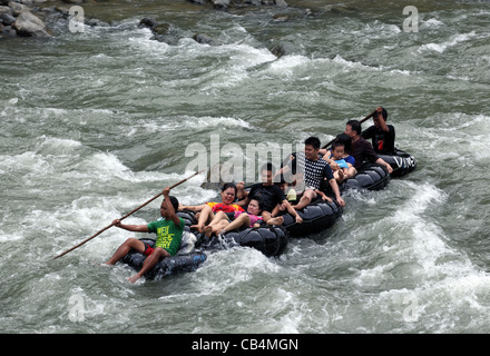 Rafting on connected inner tubes down the Bohorok River. Gunung Leuser National Park, Bukit Lawang, Sumatra, Indonesia, Asia Stock Photo