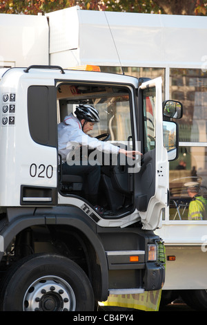 Cyclist takes a drivers eye view from the cab of an HGV at road safety event Stock Photo