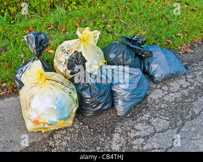 Household rubbish plastic sacks awaiting weekly collection - France. Stock Photo