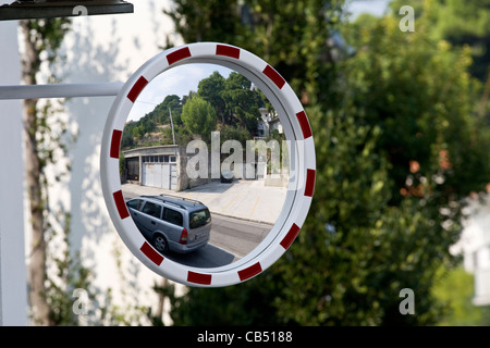 Car reflected in road traffic safety mirror to increase visibility in Croatia Stock Photo