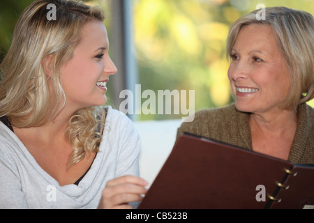 young woman and older woman at restaurant Stock Photo