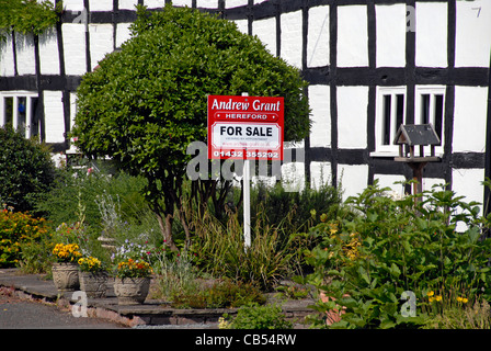 Half timbered house for sale with estate agent sign, Lingfield 