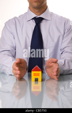 Insurance agent showing houses  isolated with reflection Stock Photo