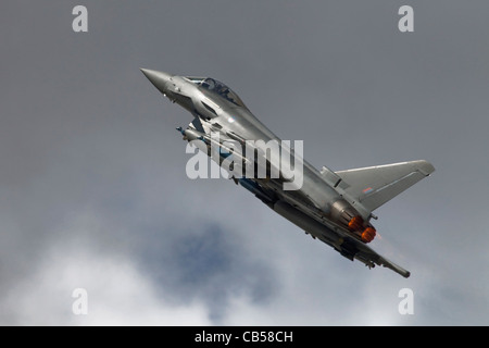 A Bae Systems Typhoon fighter of the RAF climbing away in to dark skies Stock Photo