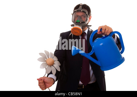 a businessman with a gas mask holding a artificial flower from the future Stock Photo