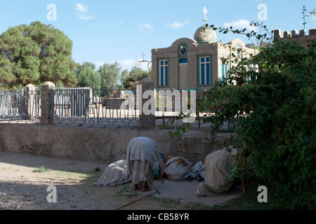 Orthodox Christian pilgrims pray outside the railings of the chapel containing the Ark of the Covenant, Aksum, Northern Ethiopia Stock Photo