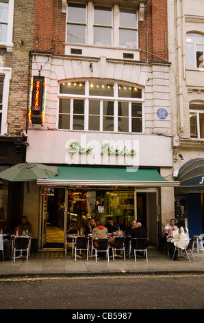 people sitting outside the Bar Italia café Frith Street Soho  London UK, over the cafe is the blue plaque of John Logie Baird Stock Photo