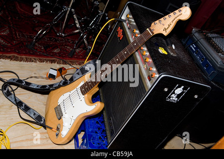 amplifier and fender stratocaster guitar on stage Stock Photo