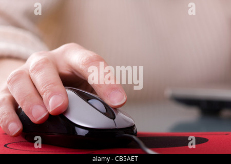 Woman hand on a mouse with copyspace (selective ans soft focus) Stock Photo