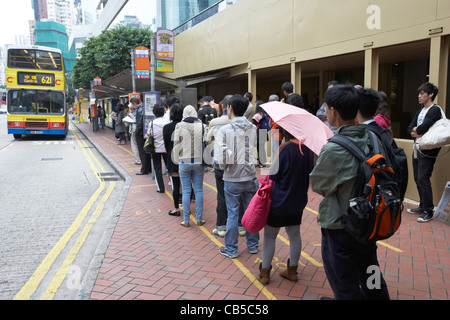 chinese people queueing for a bus in downtown admiralty district hong kong island hksar china Stock Photo