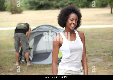 Couple pitching tend in campsite Stock Photo
