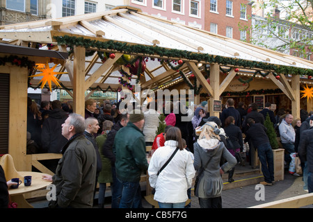 Christmas Sales and Festive Shoppers buying Goods in Piccadilly Manchester, UK Stock Photo