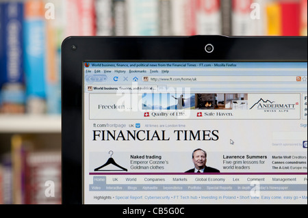 The Financial Times website shot against a bookcase background (Editorial use only: print, TV, e-book and editorial website). Stock Photo