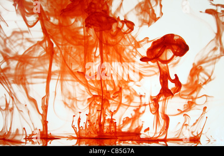Drops of Orange Food Dye in water for my Abstract A Level Project Stock Photo