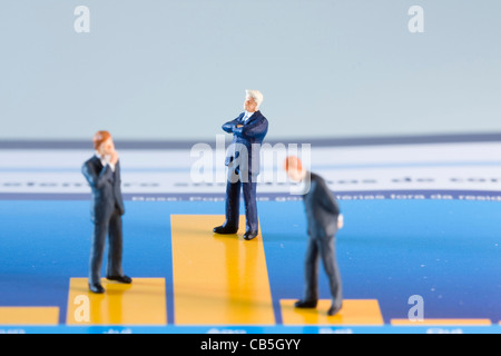 miniature businessman analysing a financial chart (selective and soft focus) Stock Photo