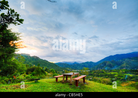 Bench looking down on Vilcabamba, Ecuador at sunset Stock Photo