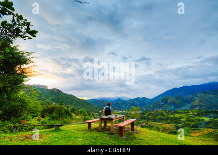 Man looking down on Vilcabamba, Ecuador at sunset Stock Photo