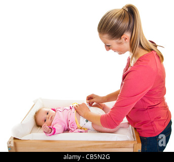 Mother changing child's diaper on nursery table isolated on white Stock Photo